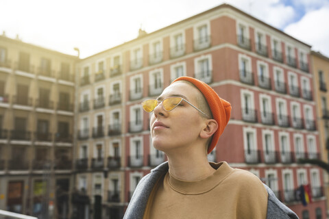 Portrait of a young woman with closed eyes in the city stock photo