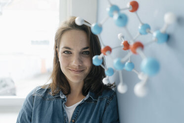 Female scientist studying molecule model, looking for solutions - KNSF05650