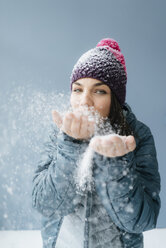 Woman wearing wooly hat, blowing snow - KNSF05684