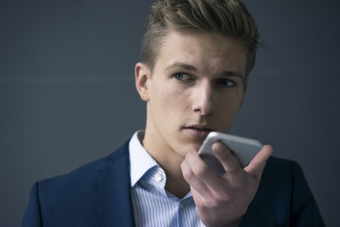 Portrait of young businessman using smartphone stock photo