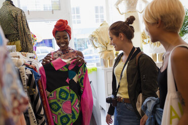 Young woman friends shopping in clothing store - CAIF22738