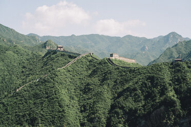 Great Wall of China on green mountain against sky during sunny day - CAVF61113