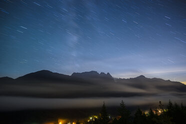 Scenic view of mountains against star trails at night - CAVF61202