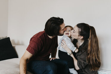 Parents kissing baby girl at home - LHPF00462