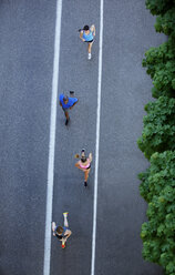 High angle view of athlete friends running on city street - CAVF61509