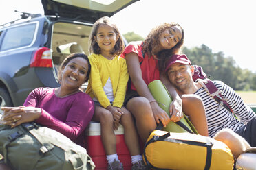 Porträt einer glücklichen Familie beim Zelten, Entladen des Autos - CAIF22798