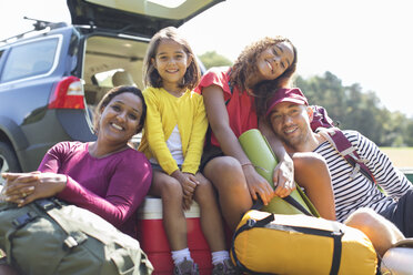 Portrait happy family camping, unloading car - CAIF22798