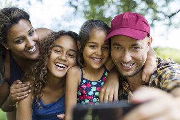 Happy family taking selfie with camera phone - CAIF22827