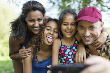 Playful family taking selfie with camera phone - CAIF22866