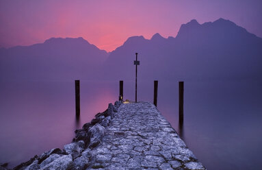 Italy, Torbole, Lake Garda, jetty at sunset - MRF01933