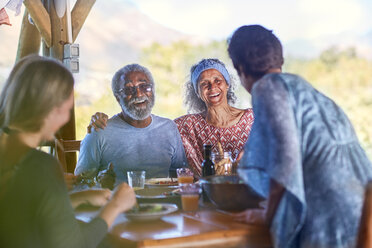 Happy senior couple enjoying breakfast on yoga retreat - CAIF22959