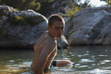 France, portrait of teenage boy bathing in lake - AMEF00004
