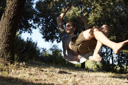 France, teenage boy on a swing at tree - AMEF00008