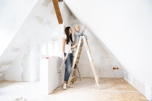 Mother and son working on loft conversion - MFRF01174