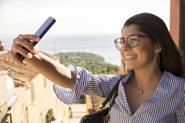 Close-up of smiling female teenager taking selfie - CAVF62168