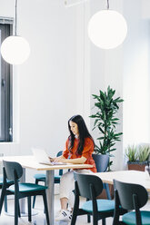 Businesswoman using laptop computer on desk in office - CAVF62265