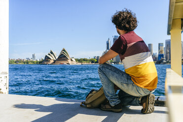 Australia, New South Wales, Sydney, man looking at the Sydney Opera House - KIJF02339