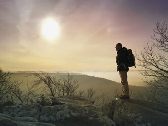 Germany, Rhineland Palatinate, Palatinate Forest, man, hiker standing on Rocks of Drachenfels - GWF05942