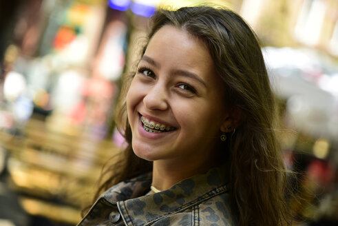 Portrait of laughing teenage girl wearing braces - MIZF00795