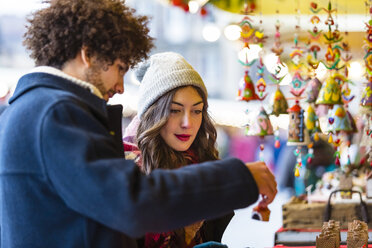 Young couple at a stall on Christmas market - MGIF00303