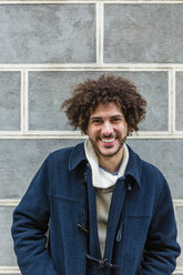 Portrait of happy young man with curly hair - MGIF00314