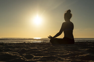 Woman in Yoga Pose on the Beach at Sunset, Religious Stock Footage