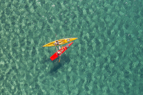 Drone shot of couple kayaking together in sea - CAVF62407