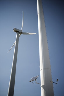 Low angle view of solar panel on Windmill against blue sky - CAVF62434