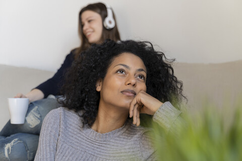 Friends relaxing at home, daydreaming stock photo