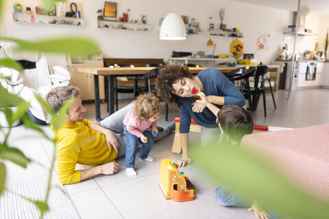 Happy family playing with their kids on a weekend stock photo