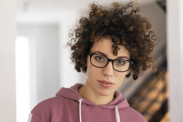 Portrait of a young woman with curly hair, wearing glasses - JOSF03126