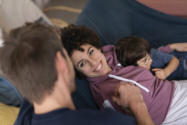 Family cuddling on couch - JOSF03131