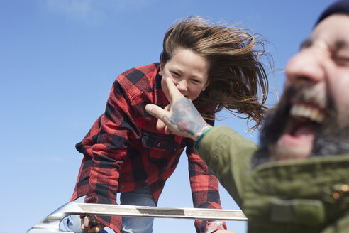 Carefree father having fun with his daughter under blue sky - AMEF00036