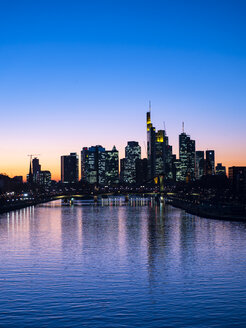 Germany, Hesse, Frankfurt, Skyline of financial district, Main river and Deutschherrn Bridge at sunset - AMF06804
