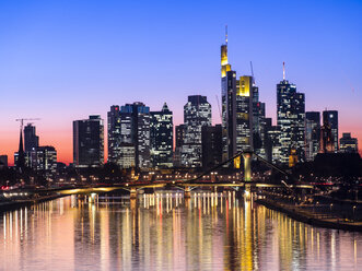 Germany, Hesse, Frankfurt, Skyline of financial district, Main river and Deutschherrn Bridge at sunset - AMF06807