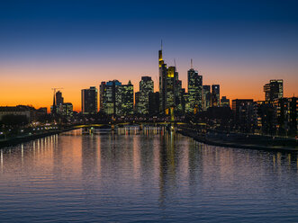 Germany, Hesse, Frankfurt, Skyline of financial district, Main river and Deutschherrn Bridge at sunset - AMF06810