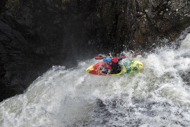 Man kayaking on waterfall on river - ALRF01432