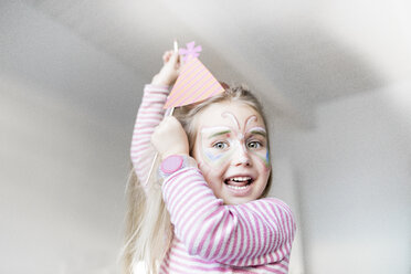 Portrait of smiling little girl made up as butterfly - KMKF00794