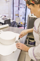 Hohe Winkel Ansicht der Bäcker Schneiden von Kuchenteig mit Pizzaschneider auf Küchenzeile im Labor - CAVF62749