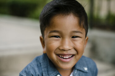 Close-up portrait of cute happy boy sitting on steps at Balboa Park - CAVF62839