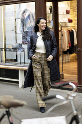 Happy woman on a shopping spree in the city - PESF01548