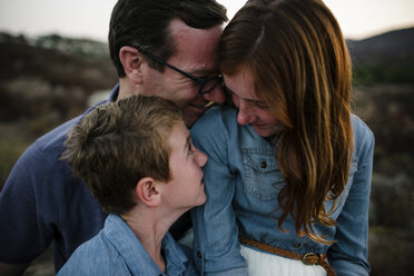 Happy father with son and daughter on field during sunset - CAVF62975