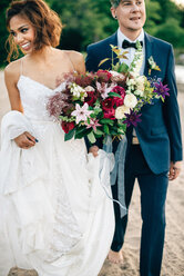 Bride and groom strolling on lakeside - ISF20958