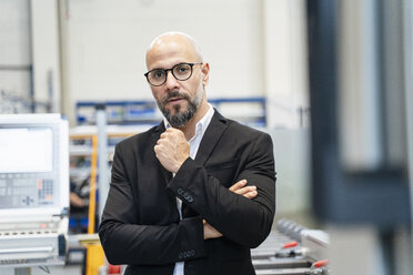 Portrait of serious businessman in a factory - DIGF06085