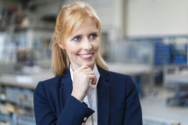 Portrait of smiling businesswoman in factory - DIGF06157