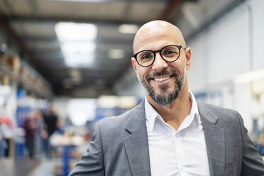 Portrait of smiling businessman in factory - DIGF06177