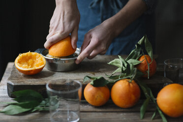 Young man's hands squeezing orange - ALBF00777