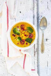 Curry dish with pumpkin, sweet potato, brokkoli, tomato, pomegranate seeds and black sesame in bowl - LVF07851