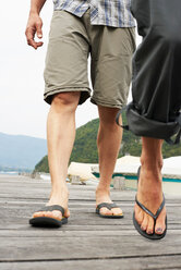 Mature couple strolling on Lake Annecy pier, cropped, Annecy, Rhone-Alpes, France - CUF49525