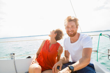 Young man and mature woman sailing on Chiemsee lake, Bavaria, Germany - CUF49602